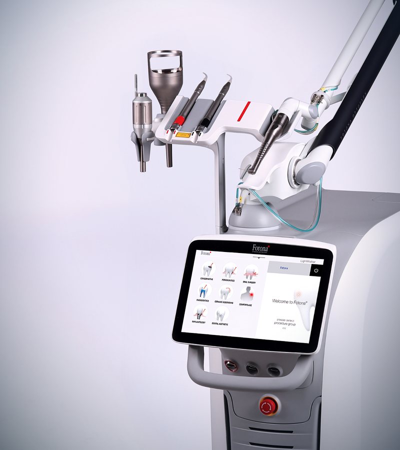 The Fotona LightWalker dental laser with its touchscreen and handpiece arm.