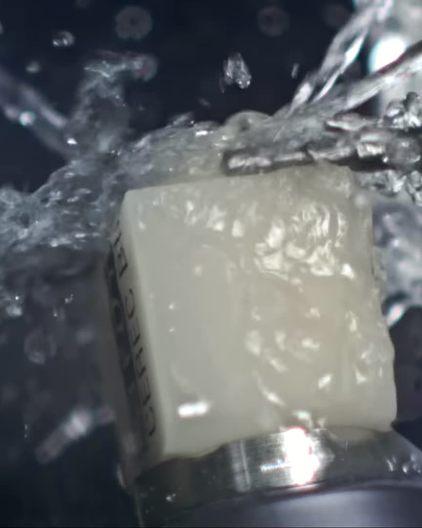 A CEREC MC XL milling unit shaping a ceramic crown from a solid block.